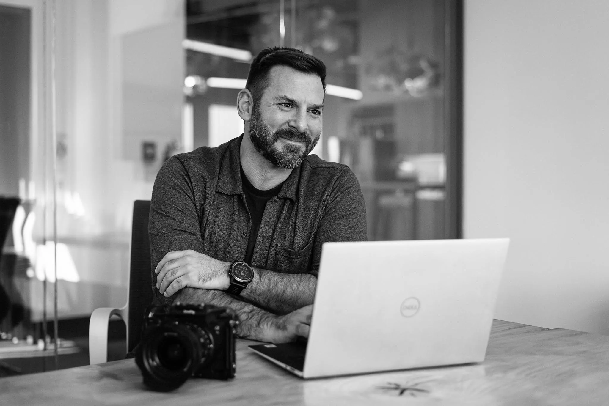 Michael Bonocore at a table with a camera and a laptop